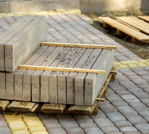 Installation of stone paving slabs in a yard. Installation of stone paving slabs in a yard.